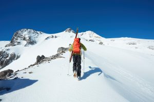 solo backcountry skier trekking