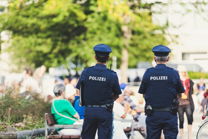 Two German police officers patrol a park in the city.