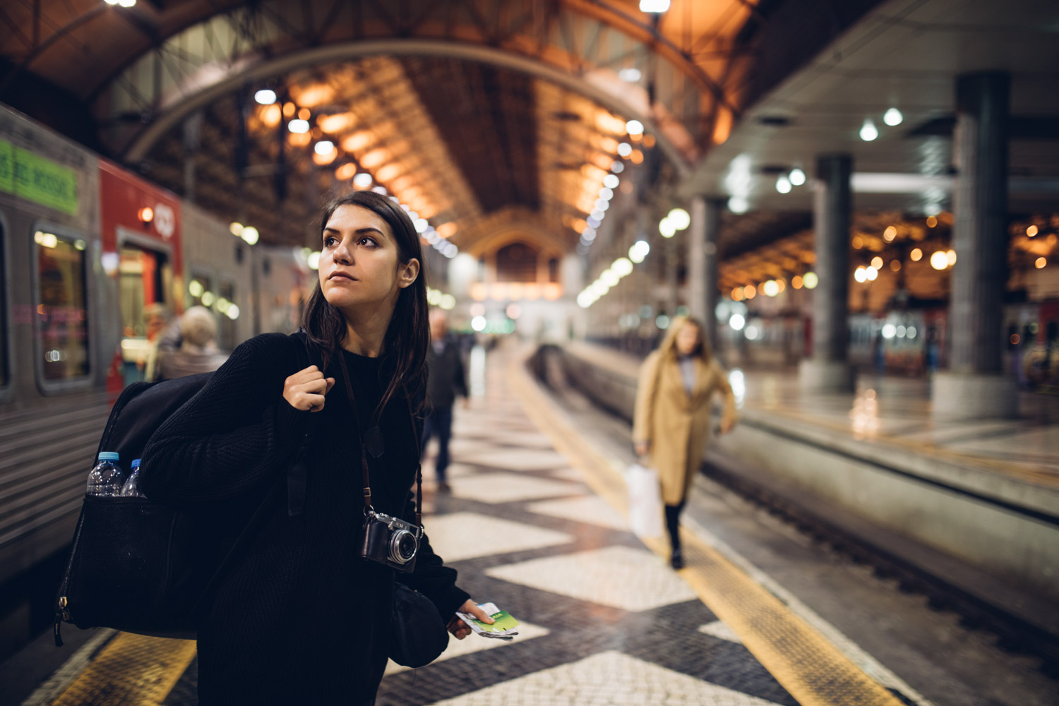 woman-on-train-platform-looking-over-her-shoulder